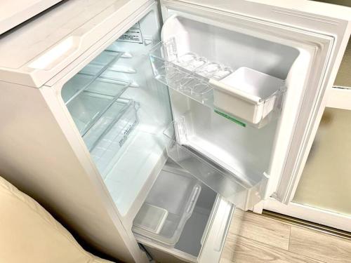 an empty refrigerator with its door open in a kitchen at COCO Nakameguro 202 in Tokyo