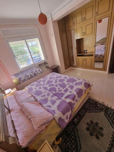 a bedroom with a large bed in a room at Tanger ahlan in Tangier