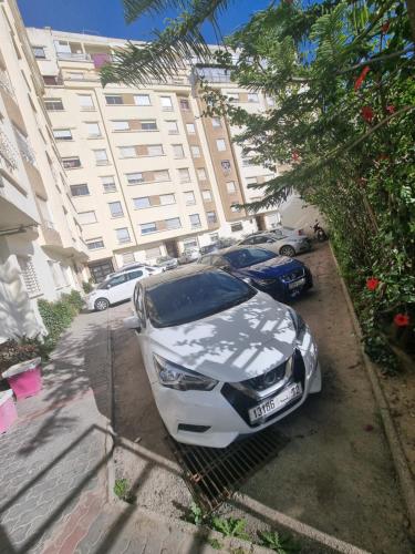 a white car parked in front of a building at Tanger ahlan in Tangier