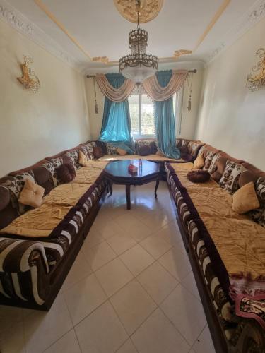 a large couch in a living room with a table at Tanger ahlan in Tangier