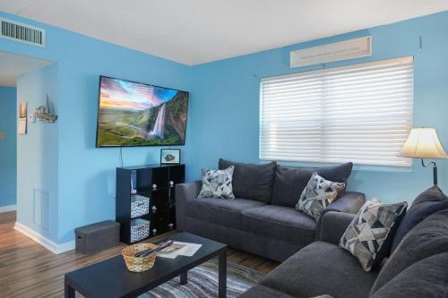 a blue living room with a couch and a table at Beautiful Blue Ocean Condo in Myrtle Beach