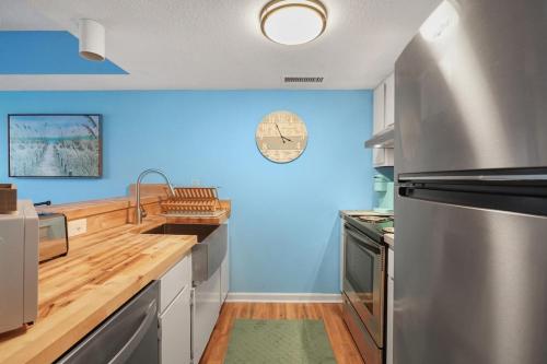 a large kitchen with blue walls and wooden counter tops at Beautiful Blue Ocean Condo in Myrtle Beach