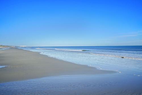 an empty beach with the ocean in the background at Beautiful Blue Ocean Condo in Myrtle Beach