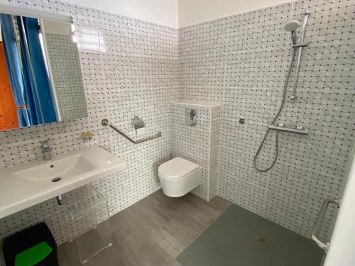 a bathroom with a toilet and a sink and a shower at Chambre indépendante vue mer et montagne in Vieux-Habitants