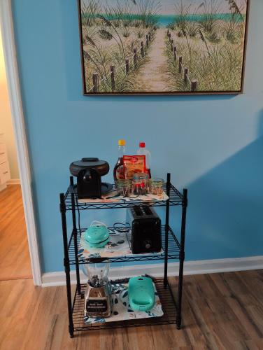 a shelf in a room with a picture on the wall at Beautiful Blue Ocean Condo in Myrtle Beach