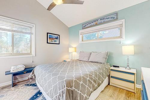 a bedroom with a bed and two tables and a window at Town of South Bethany --- 125 Elizabeth Way in Bethany Beach