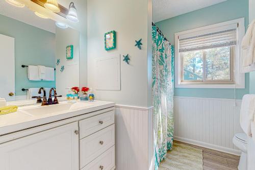 a bathroom with a sink and a toilet and a window at Town of South Bethany --- 125 Elizabeth Way in Bethany Beach