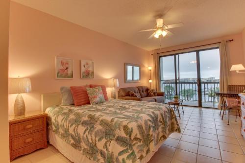 a bedroom with a bed and a balcony at Pirates Bay A415 in Fort Walton Beach