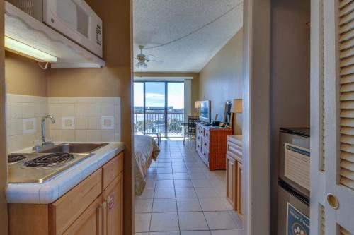 a kitchen with a sink and a view of a room at Pirates Bay A415 in Fort Walton Beach