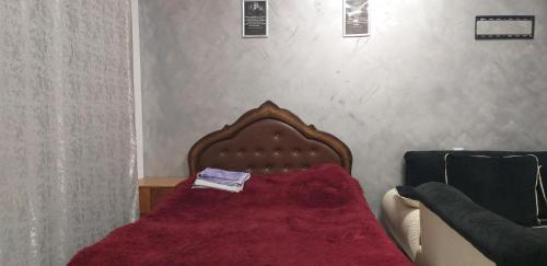 a bedroom with a bed with a red blanket on it at AKCURATE Home 105/1 in Yerevan