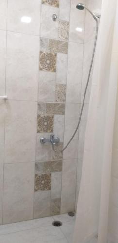 a shower with a glass door in a bathroom at AKCURATE Home 105/1 in Yerevan