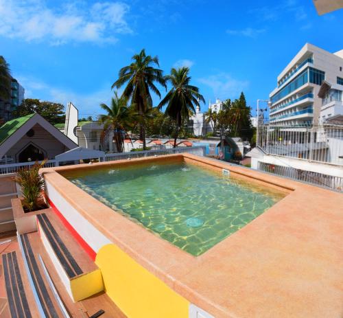 a swimming pool on the roof of a building at Hotel Nomadic Design in San Andrés