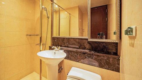 a bathroom with a sink and a toilet and a shower at Yeoksam Artnouveau City Hotel and Residence in Seoul