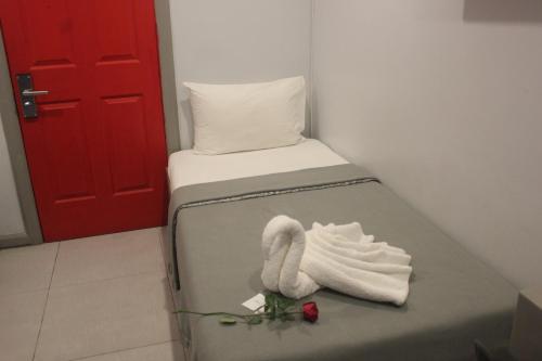 a room with a bed with a towel on it at ML SUITES CEBU in Cebu City