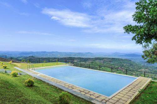 a swimming pool with a view of the mountains at Villa Labugolla in Kandy