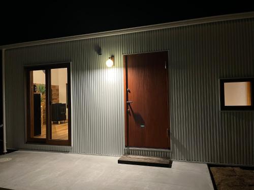 an empty room with a door and a mirror at MY LODGE Naoshima in Naoshima