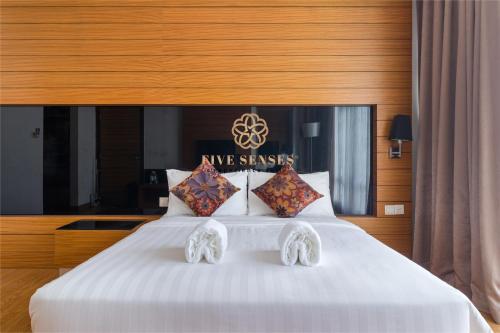 a bedroom with a large white bed with pillows at Dua Sentral Kuala Lumpur by Five Senses in Kuala Lumpur