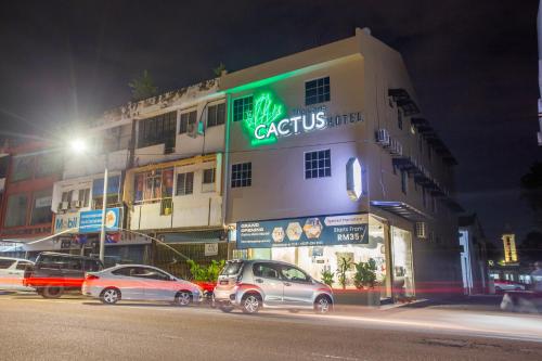 a building with cars parked in front of it at night at The Cave By Cactus Hotel Skudai in Skudai