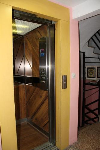 a door into a room with a wooden door with a door at Hostal Mengual in Gandía