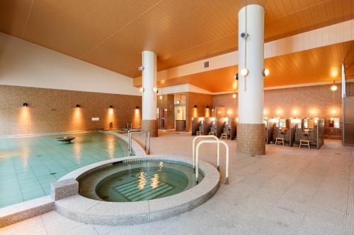 a pool in a hotel lobby with a hot tub at ManyonoyuHotelKyotoEminence in Kyoto