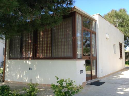 a house with large windows on the side of it at Favignana Vacanze in Favignana