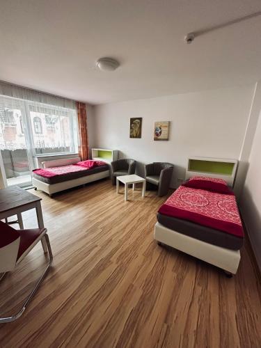 a living room with two beds and a couch at FeWo`s Katharina in Bremerhaven