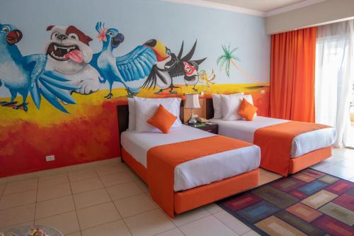 a bedroom with two beds with a mural on the wall at Parrotel Lagoon Waterpark Resort in Sharm El Sheikh
