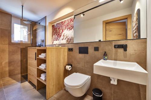 a bathroom with a white sink and a toilet at Wax-N-Stein in Garmisch-Partenkirchen