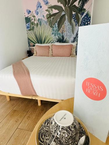 a bed in a room with a bowl on a table at Tessa's on the Beach in Gold Coast