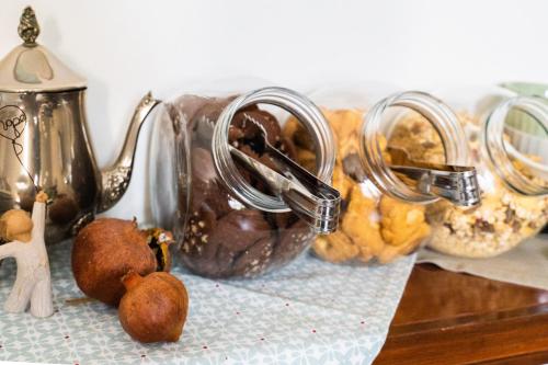 a table topped with two mason jars filled with food at Hotel Mom Assisi in Assisi