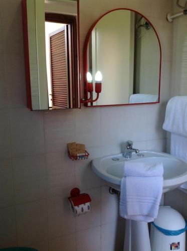 a bathroom with a sink and a mirror at Verdemare Sardegna Due Villette in Villasimius