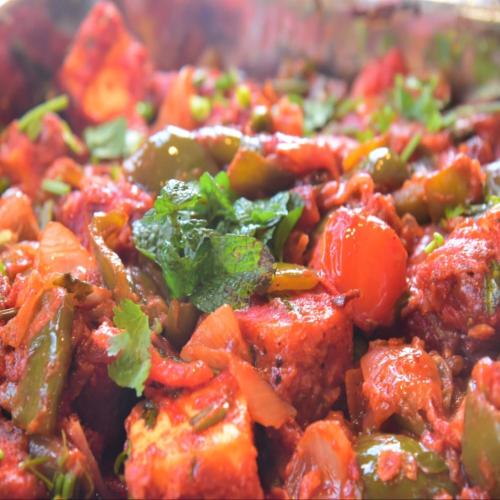 a close up of a dish of food with vegetables at Amaira Resort & Farms - Mirik, West Bengal in Mirik