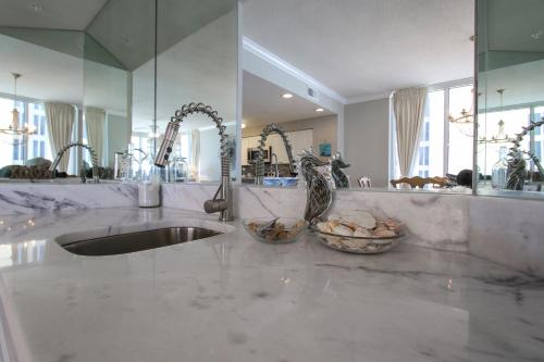 a bathroom counter with a sink and a mirror at Incredible Great Deals On This Hidden Gem Gulf Front Condo at The Pearl Sleeps 8 in Navarre