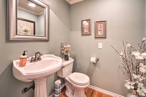 a bathroom with a sink and a toilet and a mirror at Stunning Kent Lake House with Private Dock! in Kent