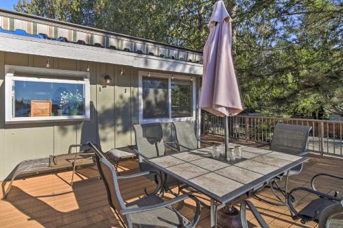 a patio with a table and an umbrella on a deck at Stunning Kent Lake House with Private Dock! in Kent