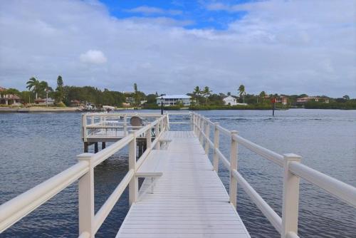 a wooden dock in the middle of a body of water at Charming Two Bedroom Condo With Pool View Siesta Key Bay Oaks in Siesta Key