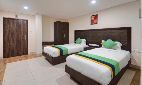 a hotel room with two beds in a room at Treebo Vetri Supreme Residency in Chennai