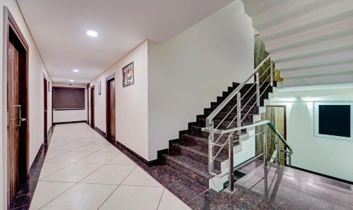 a hallway with stairs in a house at Treebo Vetri Supreme Residency in Chennai