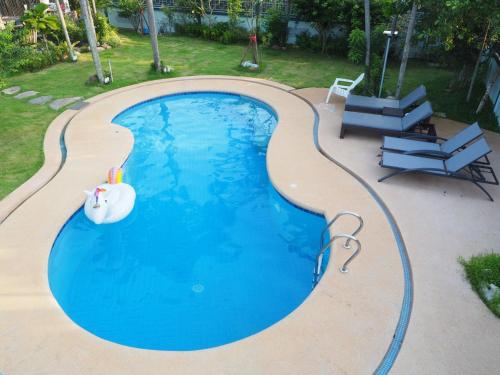 a swimming pool with an inflatable pool toy in the middle at Let's Chill Pool Villa Pattaya Najomtien42 and Sattahip in Ban Tao Than