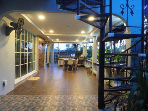 a porch with a spiral staircase in a house at Let's Chill Pool Villa Pattaya Najomtien42 and Sattahip in Ban Tao Than