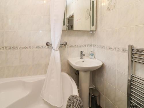 a bathroom with a sink and a toilet and a bath tub at Peacehaven in Liskeard