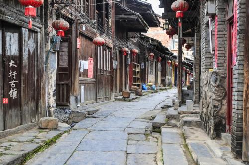 an alley in an asian city with red lanterns at Wing Hotel Guilin - Central Square in Guilin