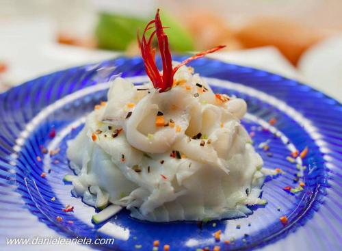 a blue plate of food with shrimp on it at La Bruca Resort in Scalea