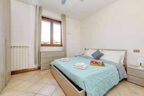 a bedroom with a bed with a tray of fruit on it at Appartamento Al Cascinale in Desenzano del Garda