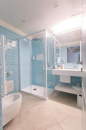 a bathroom with a shower and a sink and a toilet at Oasi Blu Sardinia in Santa Margherita di Pula