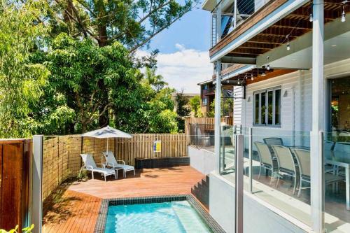 a house with a swimming pool and a patio at Large Tugun Modern House minutes to the beach in Gold Coast