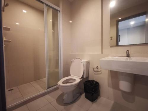 a bathroom with a toilet and a sink and a shower at The Base Pattaya in Pattaya Central