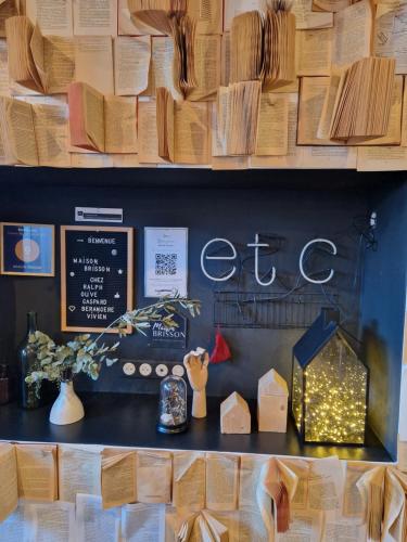 a shelf with books and a sign that says letuce at Maison Brisson in Talence