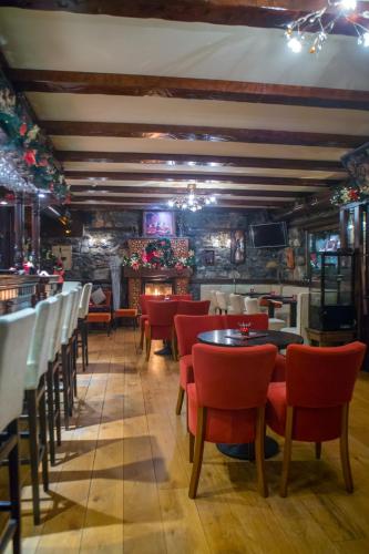 a restaurant with tables and chairs and a bar at Patriko Mountain Chalet in Palaios Agios Athanasios
