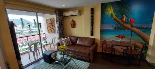 a living room with a couch and a table at Tira Tiraa Condominium in Hua Hin